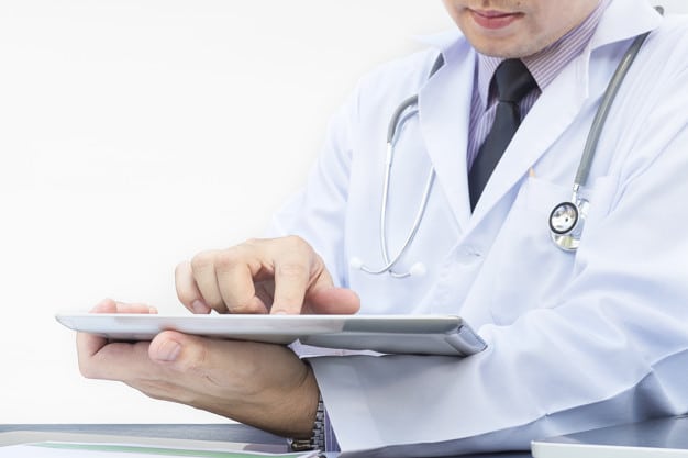 doctor is working with tablet white background 1150